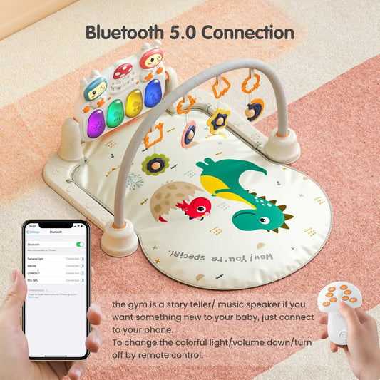 Dinosaur-themed baby play gym with Bluetooth 5.0 connection, colorful light-up piano keyboard, hanging rattles, remote control, and smartphone pairing for music and storytelling.