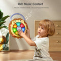 A young child plays with a hedgehog-shaped musical toy featuring colorful illuminated buttons. The toy is held upright while the child presses the glowing panels, showcasing its 