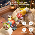 Colorful plush caterpillar toy with attached smiling bee and pineapple teether draped over a sofa arm in a softly lit room, highlighting its multi-sensory benefits for hearing, visual development, entertainment, and safe materials