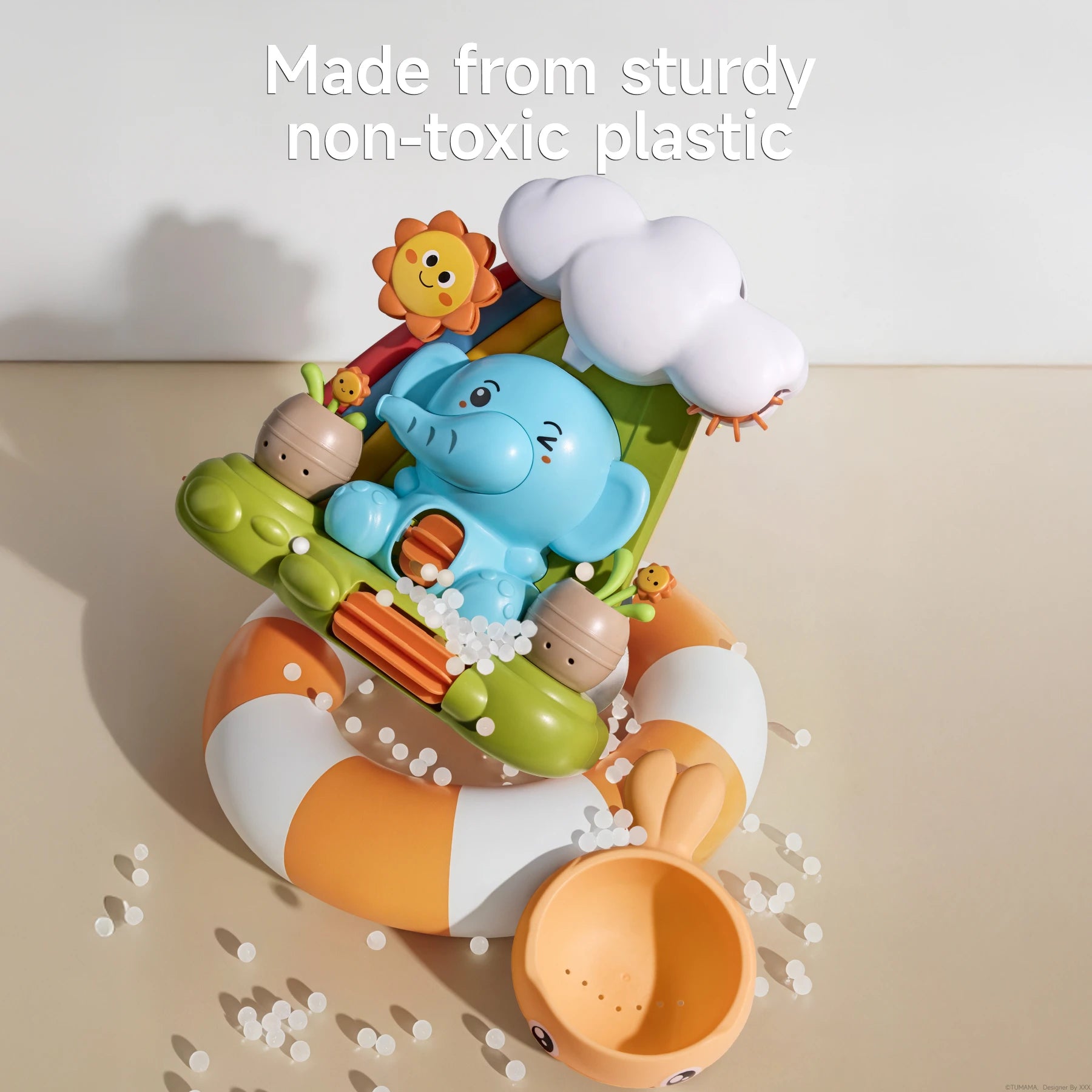 Colorful elephant-themed toddler bath toy set with a smiling elephant, cloud, and sunflower design, displayed with non-toxic plastic pellets and a bunny-ear water scoop to emphasize safe and sturdy materials.