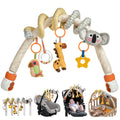 Plush spiral stroller arch toy with hanging rattles and teethers. Features a colorful parrot with clear bead ring, plush giraffe, yellow star teether, and a soft koala head on the arch. Designed for stroller, crib, or car seat entertainment.