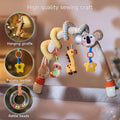 Plush koala-themed spiral arch toy attached to a crib, with hanging giraffe, parrot, banana-shaped teether, and rattle beads. Caption reads “High quality sewing craft.” Close-up insets highlight the hanging giraffe, banana teether, and rattle beads.