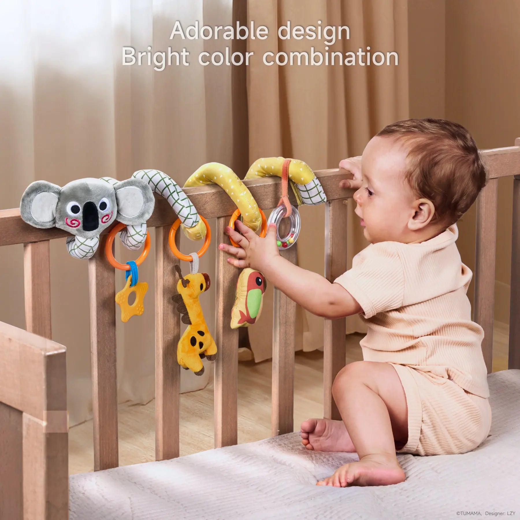 Baby standing in a crib, interacting with a koala-themed spiral activity toy wrapped around the crib rail, featuring hanging plush toys including a star teether, giraffe, colorful bird, and rattle ring, promoting sensory development through bright colors and engaging textures.