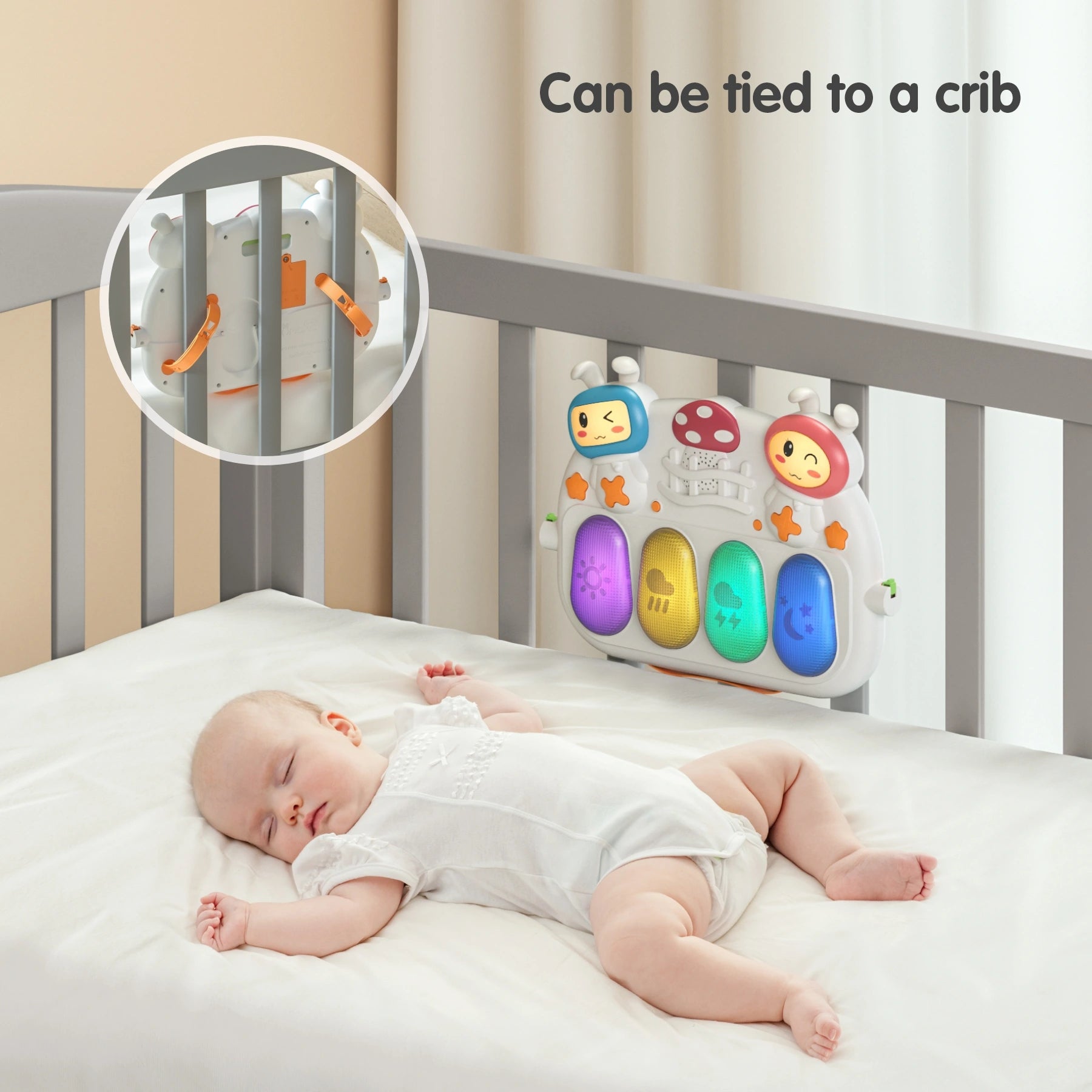 Baby sleeping peacefully in crib with light-up musical keyboard toy tied to crib bars, showing secure strap attachment.