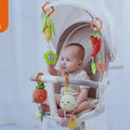 Baby-playing-with-hanging-vegetable-rattles-in-stroller