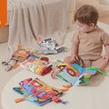 Little-boy-reads-COLORFUL-cloth-books-on-the-ground