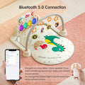 Dinosaur-themed baby play gym with Bluetooth 5.0 connection, colorful light-up piano keyboard, hanging rattles, remote control, and smartphone pairing for music and storytelling.
