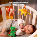 Plush dinosaur toy hanging over crib